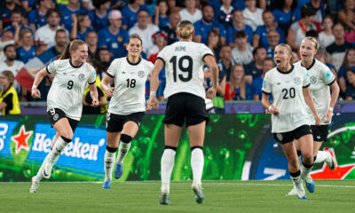 Germany players run toward Klara Bühl to celebrate their penalty shootout victory against France in the UEFA Women's Euro 2025 quarterfinal at St. Jakob-Park in Basel, Switzerland.