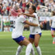 Photo of Tirnity Rodman and Alyssa Thompson embracing and celebrating a goal.
