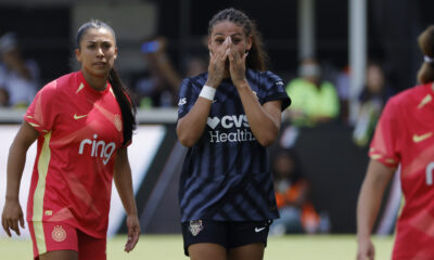 Trinity Rodman covers her mouth with both hands, reacting to her goal.