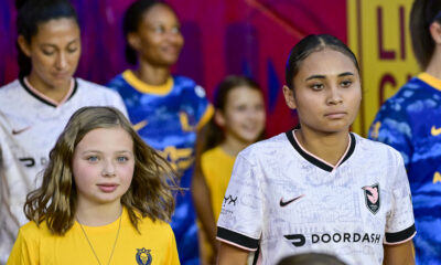 Alyssa Thompson waits with a mascot to exit the tunnel before Angel City's match against the Utah Royals in Sandy, Uutah on August 15, 2025.