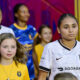 Alyssa Thompson waits with a mascot to exit the tunnel before Angel City's match against the Utah Royals in Sandy, Uutah on August 15, 2025.