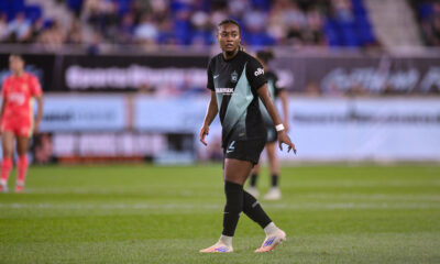 Jaedyn Shaw looks directly at the camera watching the play.